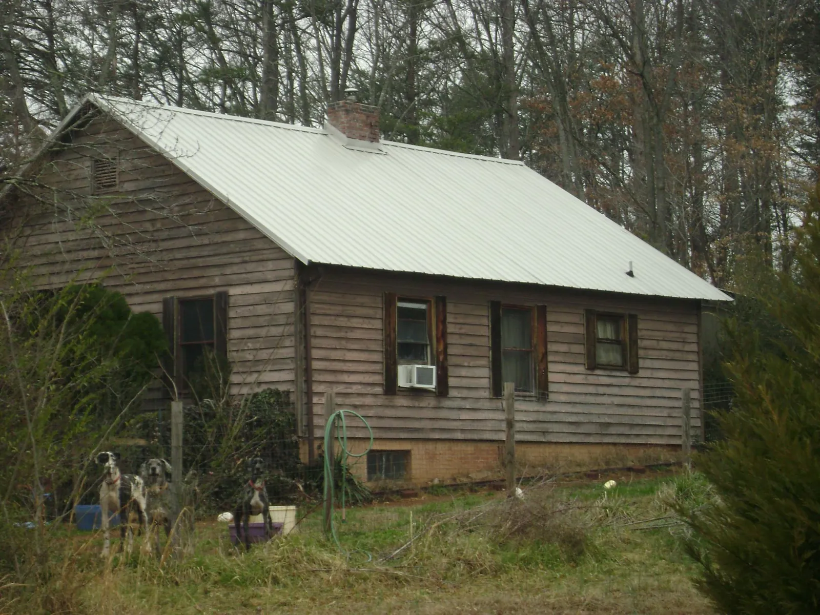 White metal roof on an old wood sided farmhouse, from a Metal Roof Installation job in Barnstead